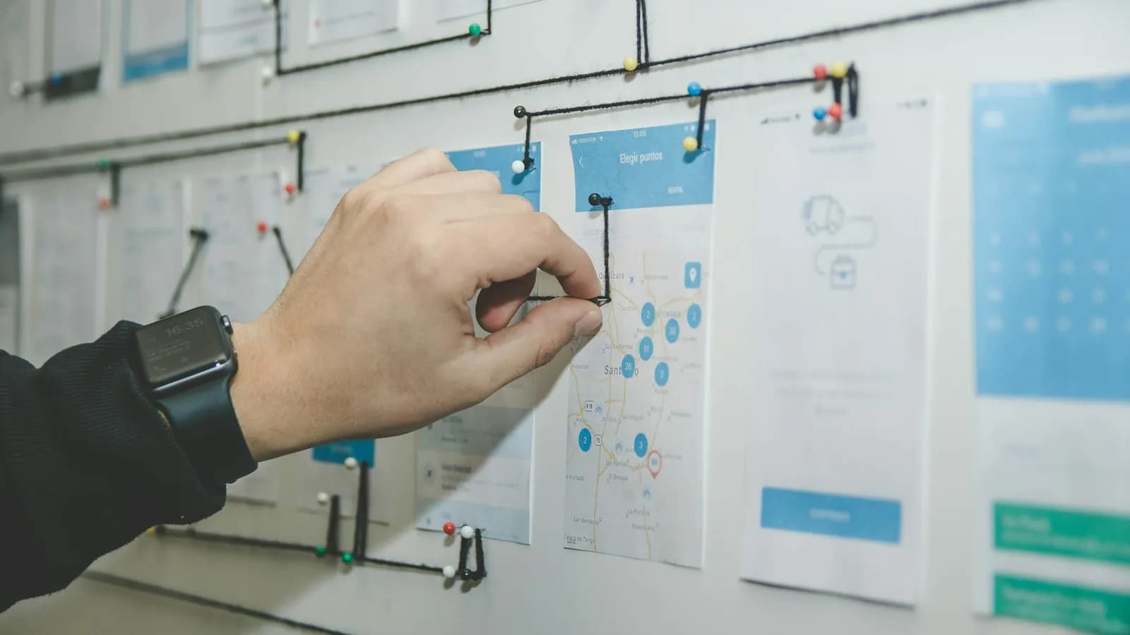 Product wireframes pinned to a planning wall